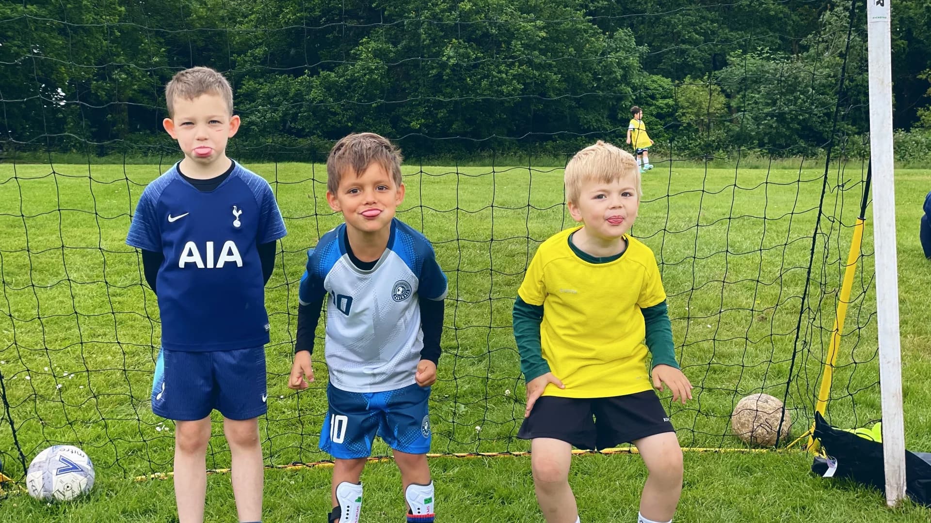 Aleks and his football friends posing together on the football field